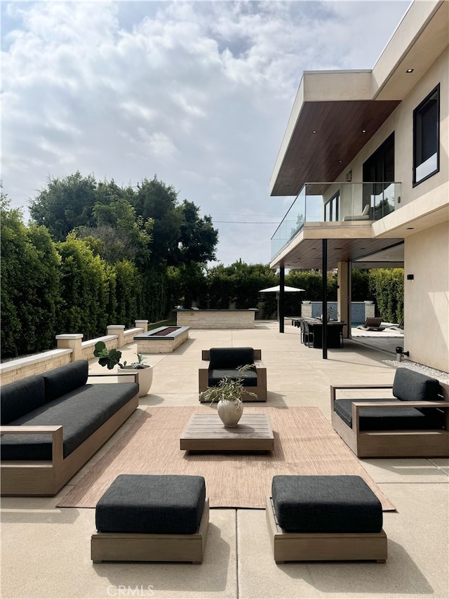 view of patio / terrace with a balcony and outdoor lounge area