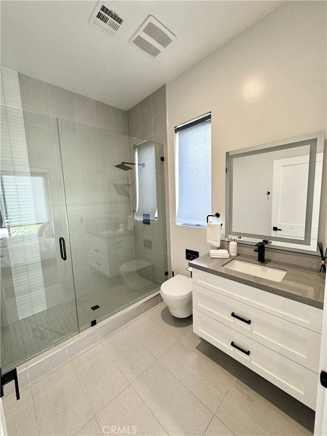 bathroom with vanity, a shower with shower door, toilet, and tile patterned flooring