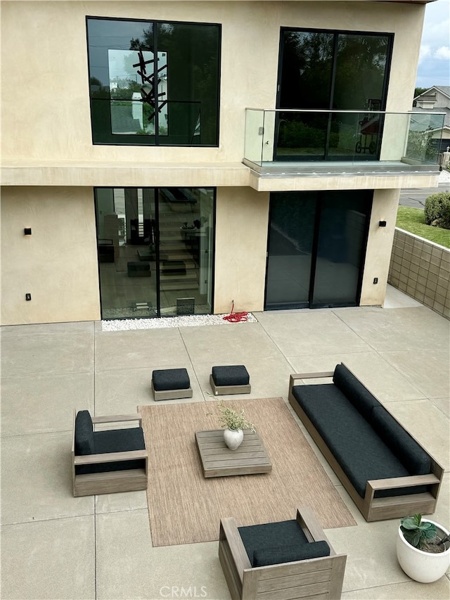 back of house with a patio and an outdoor living space