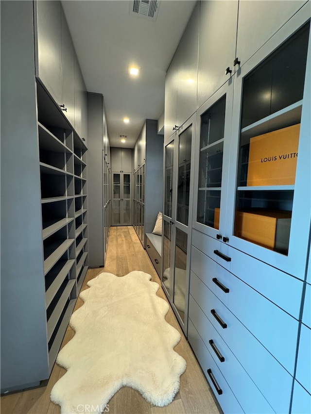 walk in closet featuring light hardwood / wood-style flooring