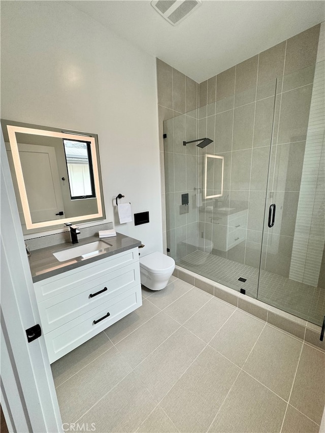 bathroom with vanity, toilet, tile patterned flooring, and an enclosed shower