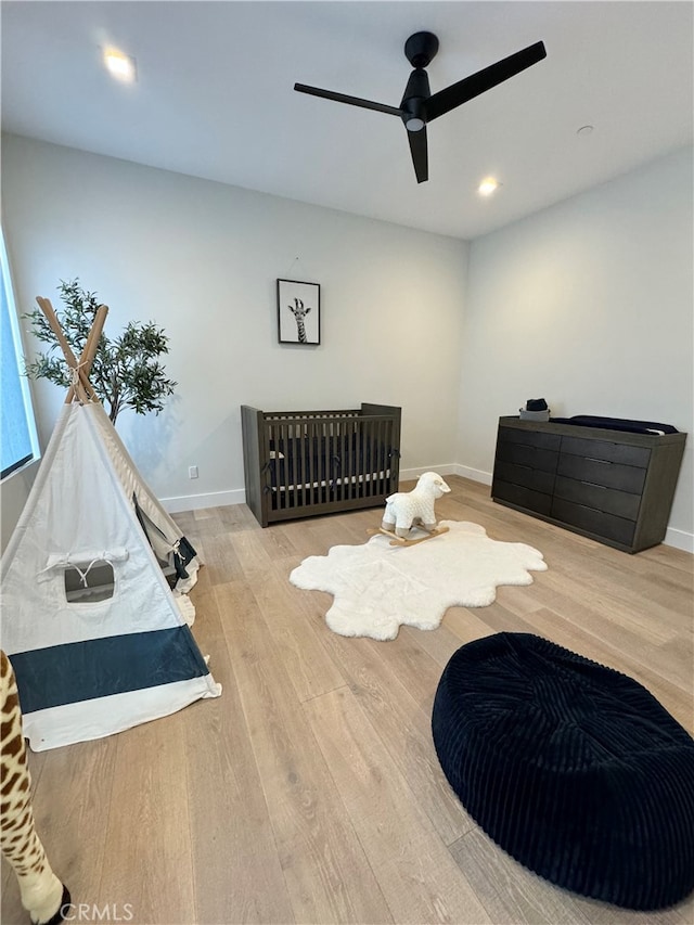 bedroom with light wood-type flooring and ceiling fan