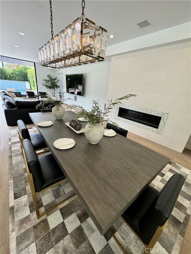 dining room with hardwood / wood-style flooring and a chandelier