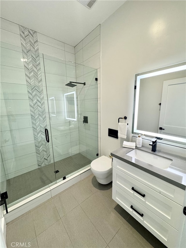 bathroom with vanity, toilet, and an enclosed shower