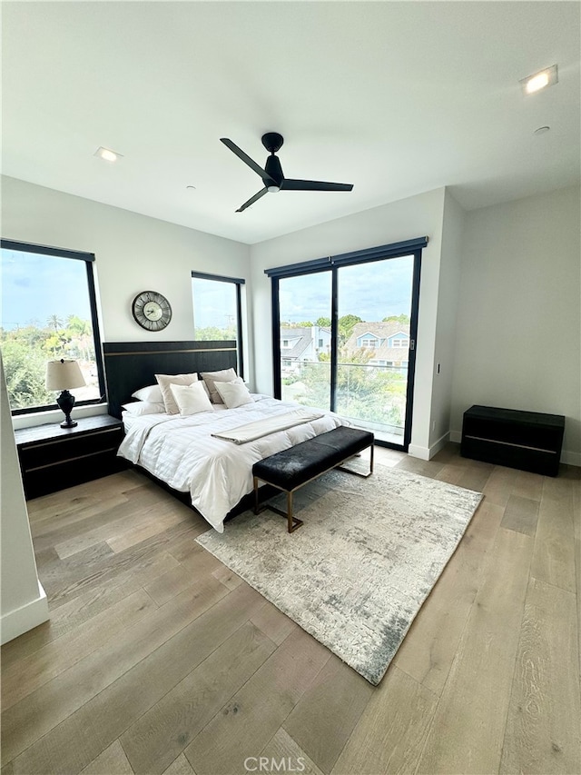 bedroom with light hardwood / wood-style floors and ceiling fan