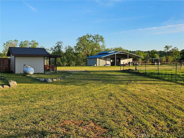 view of yard with a rural view and an outbuilding