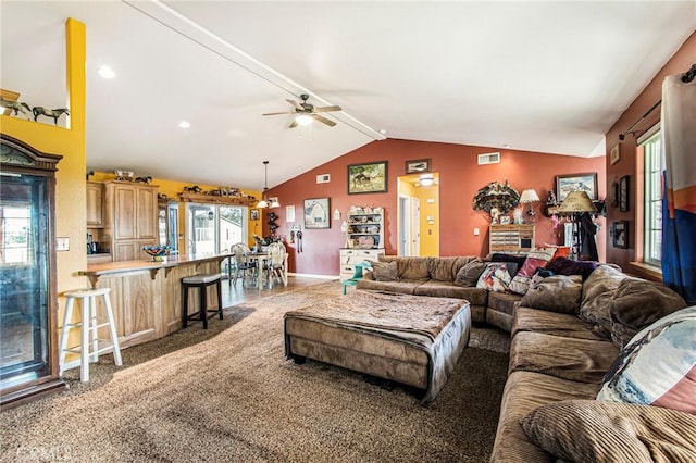 carpeted living room featuring plenty of natural light, ceiling fan, and vaulted ceiling