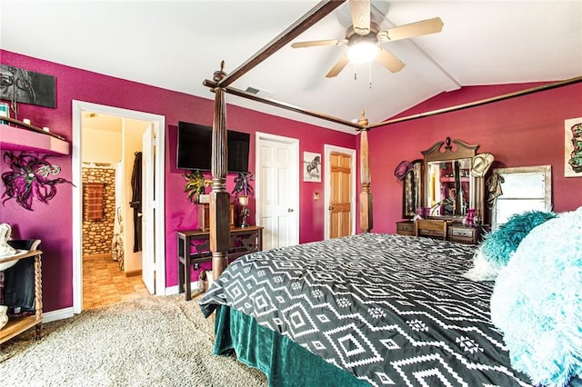 bedroom with ceiling fan, carpet floors, ensuite bathroom, and vaulted ceiling