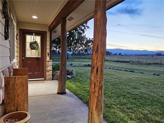 exterior space with a lawn, a mountain view, and a rural view