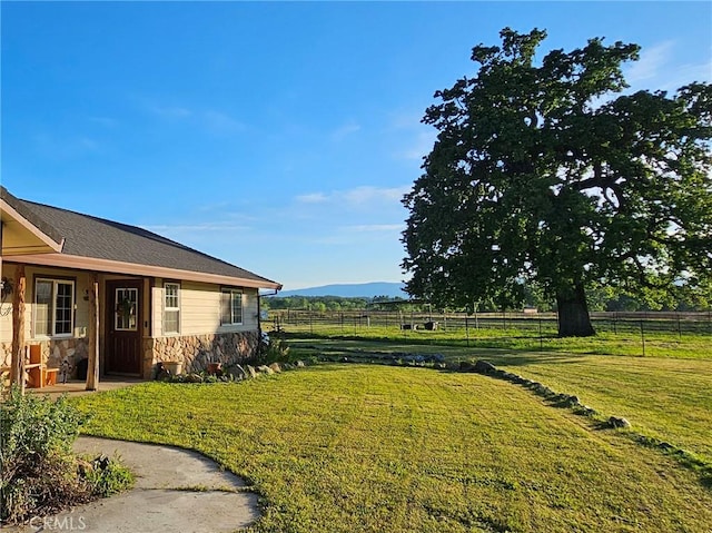 view of yard with a mountain view and a rural view