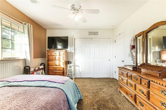 carpeted bedroom featuring a closet, ceiling fan, and radiator heating unit