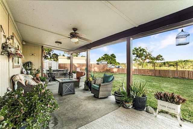 view of patio / terrace with a fire pit, ceiling fan, and a storage unit