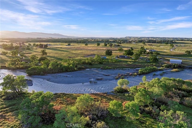 aerial view with a water and mountain view and a rural view