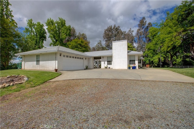 view of front facade with a front yard and a garage