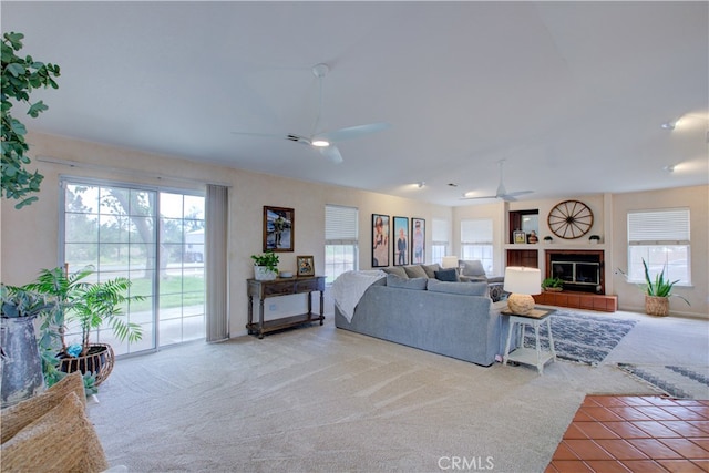 carpeted living room featuring ceiling fan