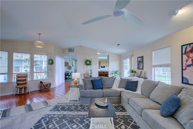 living room featuring a wealth of natural light, tile floors, ceiling fan, and lofted ceiling