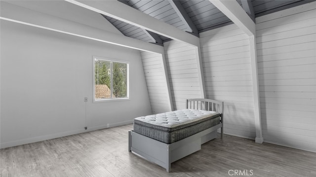 bedroom featuring vaulted ceiling with beams, wood ceiling, and light hardwood / wood-style flooring