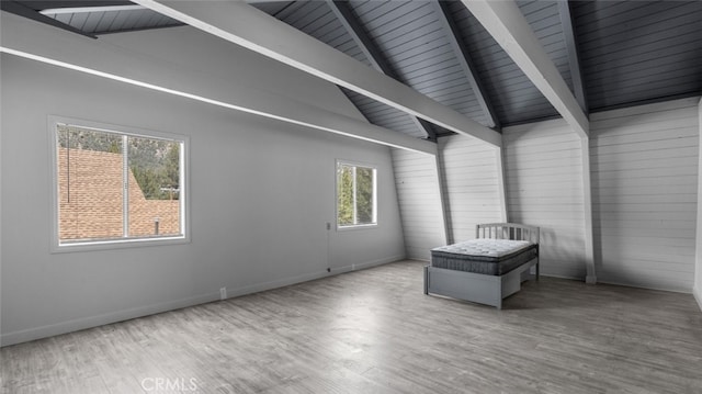 empty room featuring vaulted ceiling with beams, wood ceiling, and wood-type flooring