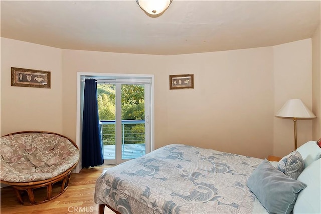 bedroom featuring light hardwood / wood-style floors and access to exterior