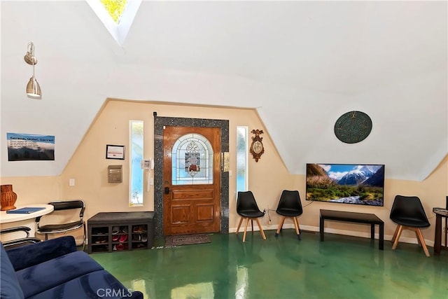 interior space featuring concrete floors and vaulted ceiling