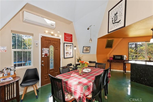 dining room featuring a healthy amount of sunlight and a wall unit AC