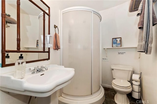 bathroom featuring toilet, tile patterned floors, and walk in shower