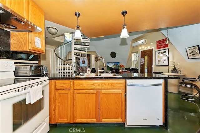 kitchen with sink, a wall unit AC, extractor fan, decorative light fixtures, and white appliances