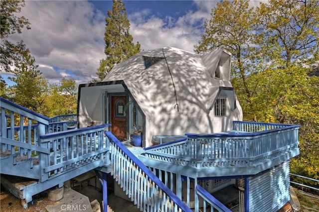 back house at dusk with a deck