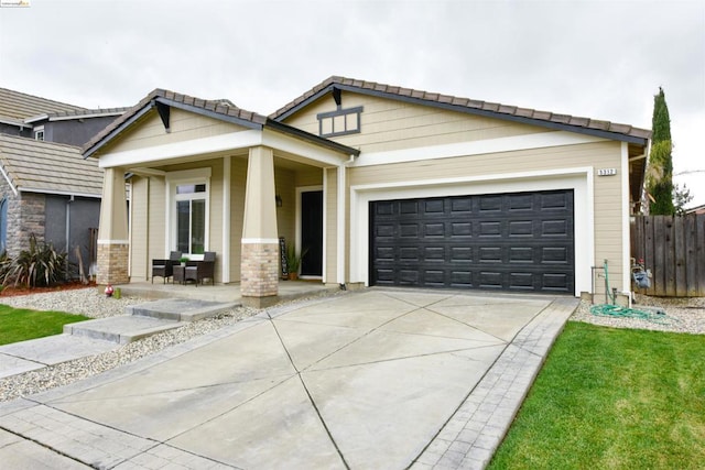 view of front of home with covered porch and a garage