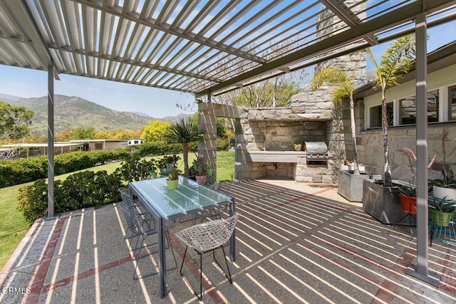 view of terrace with a mountain view, a pergola, and area for grilling