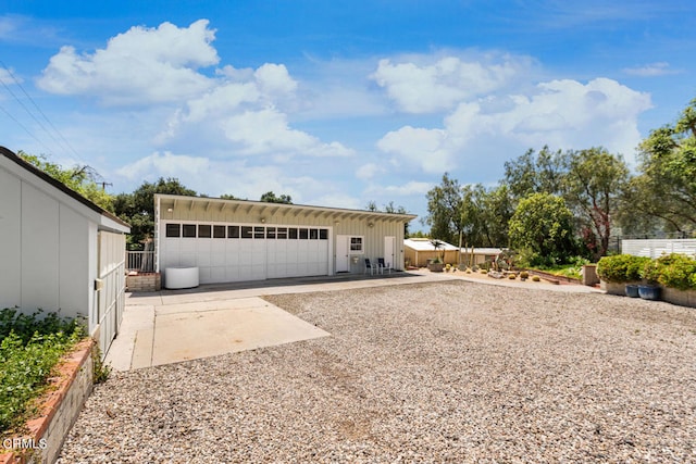 view of front of home with a garage and an outdoor structure