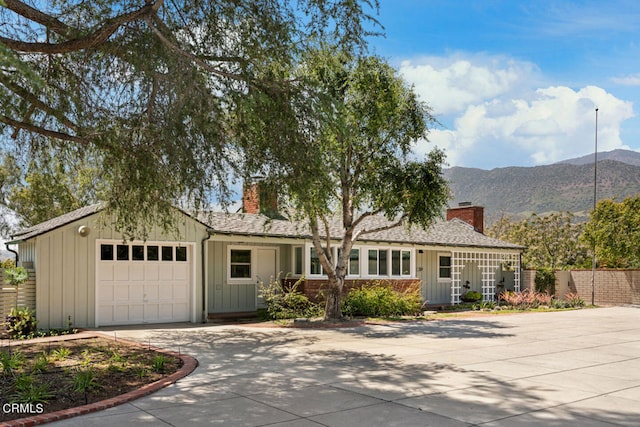 single story home featuring a garage and a mountain view