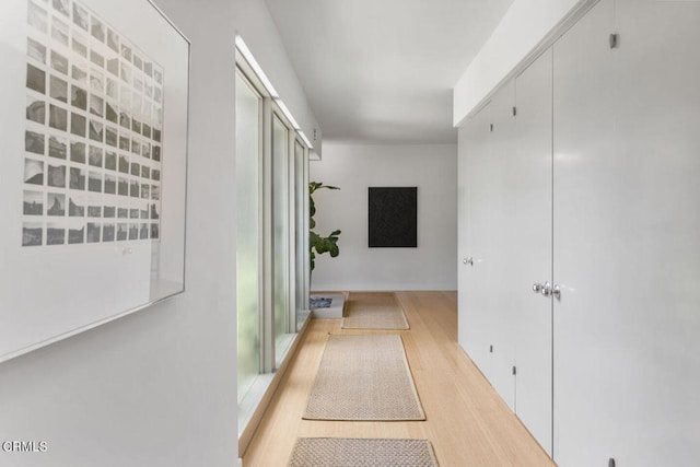 corridor with light hardwood / wood-style flooring