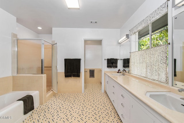 bathroom featuring dual bowl vanity, tile floors, and shower with separate bathtub