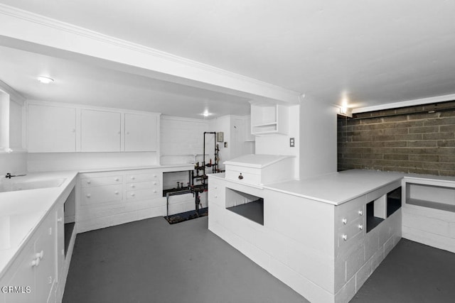 kitchen featuring sink and white cabinetry