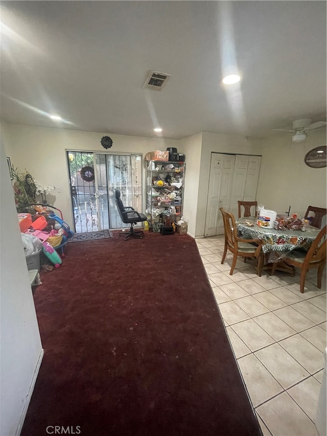 dining area with ceiling fan and light tile floors