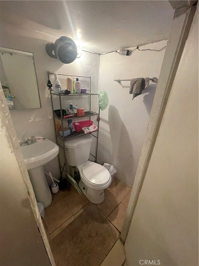 bathroom featuring toilet and tile flooring