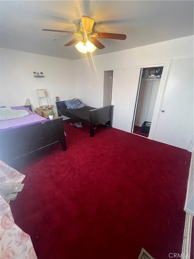 bedroom with a closet, carpet floors, and ceiling fan