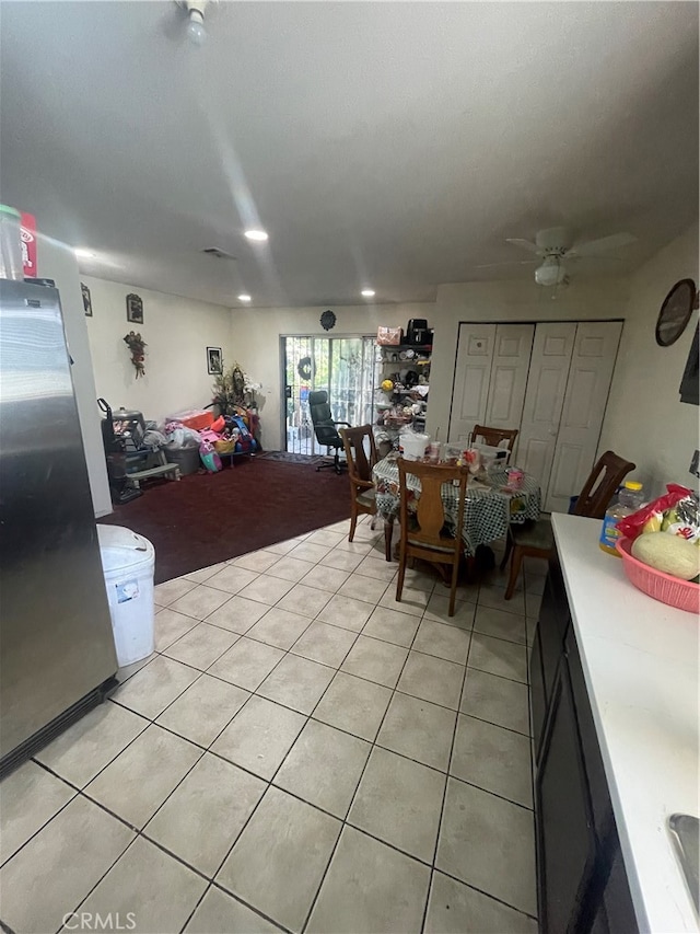 kitchen featuring stainless steel refrigerator, ceiling fan, and light tile floors