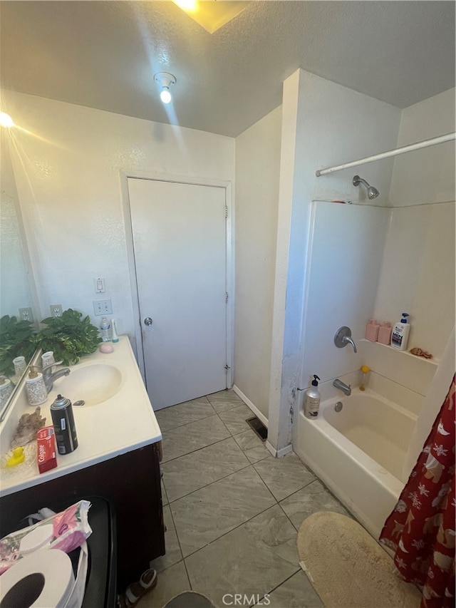 full bathroom with shower / bath combo, tile floors, vanity, toilet, and a textured ceiling