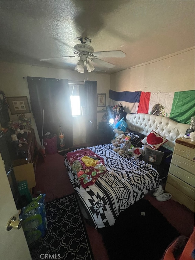 bedroom with ceiling fan and a textured ceiling