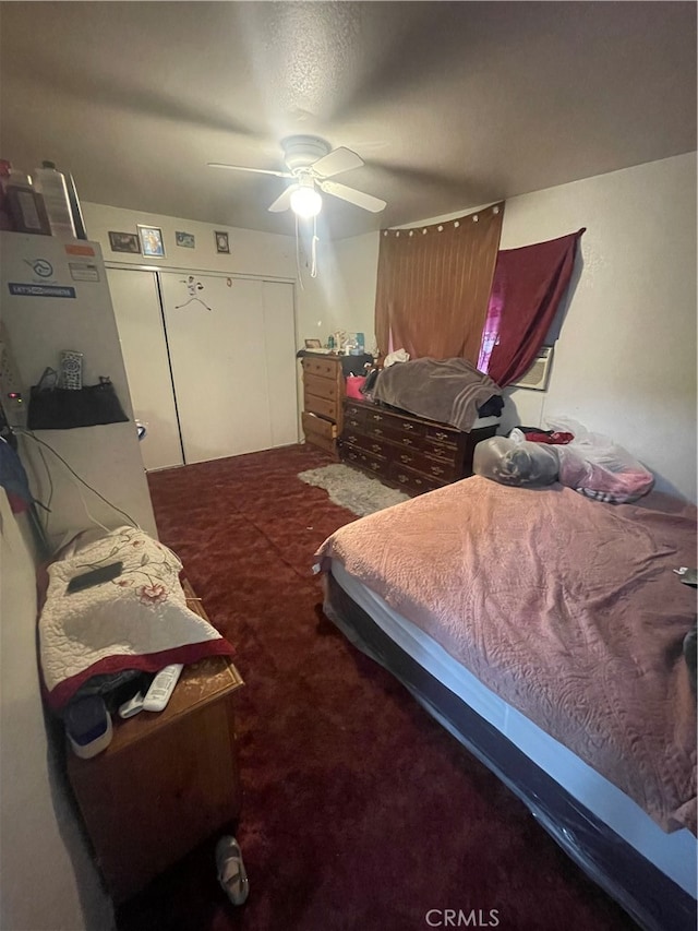 bedroom featuring a closet, ceiling fan, and carpet floors