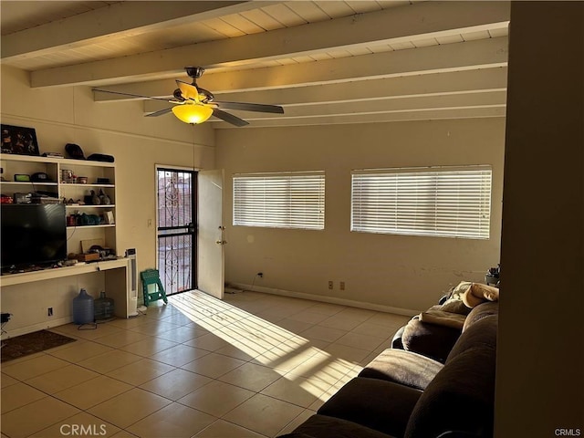 living room featuring ceiling fan, beamed ceiling, and light tile patterned floors