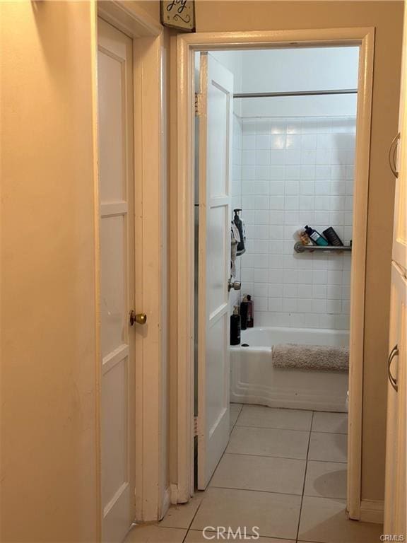 bathroom with tile patterned flooring and tiled shower / bath