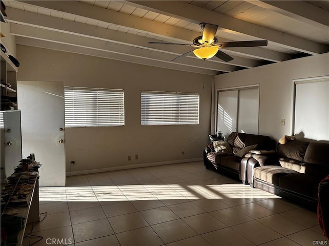 tiled living room with ceiling fan, beam ceiling, and wooden ceiling