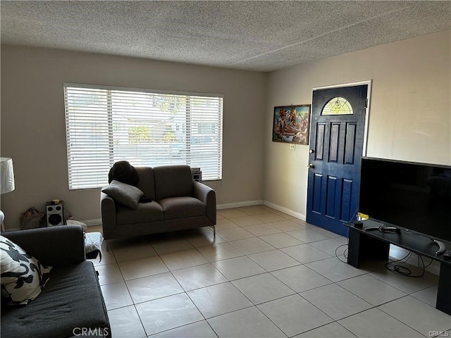 living room featuring light tile patterned floors and a textured ceiling