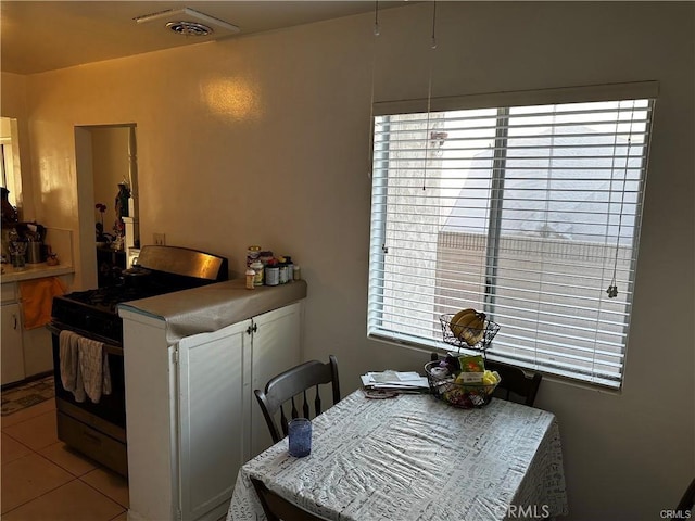 dining area featuring light tile patterned flooring and a wealth of natural light