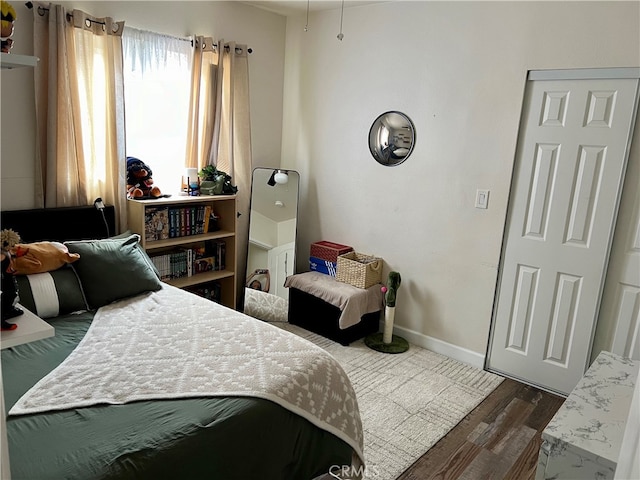 bedroom with wood-type flooring