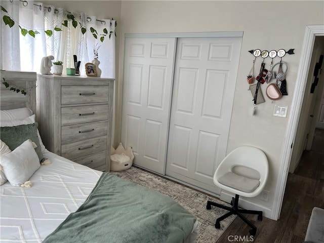 bedroom with a closet and hardwood / wood-style floors