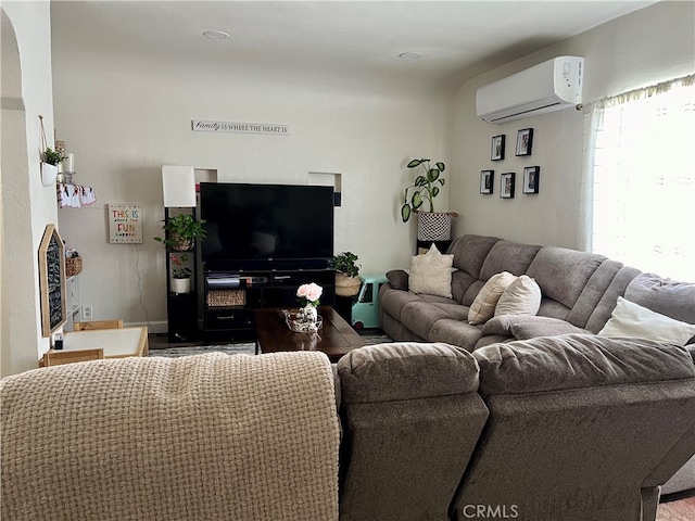 living room featuring an AC wall unit